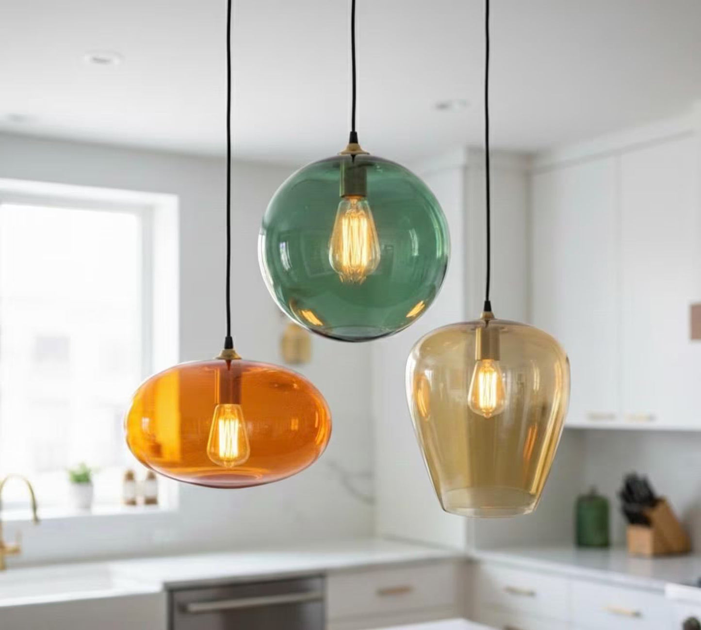 Set of three blown glass light pendants for kitchen decor | Les Trois Pyramides.
